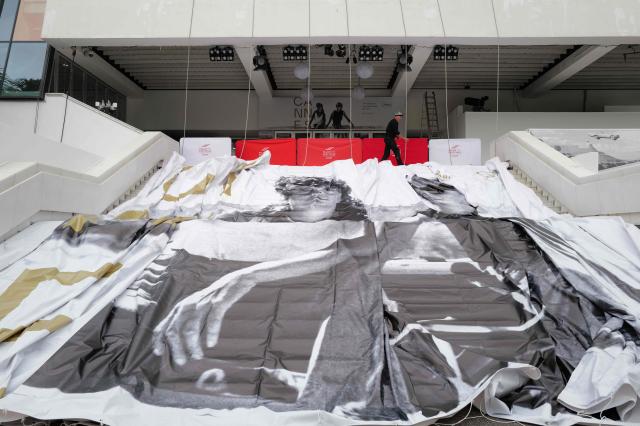 This photograph shows the official poster of the 78th Cannes Film Festival set to be hanged on the facade of the Palais des Festivals in Cannes, south-eastern France on May 10, 2026. The Cannes Film festival will take place from May 12 to May 23, 2026. (Photo by Valery HACHE / AFP)