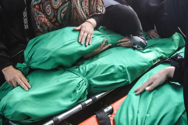 Lebanese women grieves over the bodies of the nine people killed the day before in an Israeli airstrike on the southern Lebanese village of Jibshit, during their funeral in the city of Sidon on May 10, 2026. Israel carried out strikes across Lebanon on May 9, 2026, killing at least nine people, in the south according to authorities, with raids also targeting a highway not far from Beirut outside of Hezbollah's traditional strongholds. Lebanon was drawn into the Middle East war on March 2 when Tehran-backed militant group Hezbollah launched attacks on Israel to avenge the killing of the Iranian leader. Israel has responded with broad strikes across Lebanon and a ground offencive. (Photo by Mahmoud ZAYYAT / AFP)