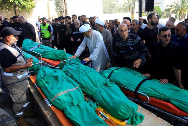 A Shia Muslim sheikh leads the prayers over the bodies of nine people killed the day before in an Israeli airstrike on the southern Lebanese village of Jibshit, during their funeral in the city of Sidon on May 10, 2026. Israel carried out strikes across Lebanon on May 9, 2026, killing at least nine people in the south according to authorities, with raids also targeting a highway not far from Beirut outside of Hezbollah's traditional strongholds. Lebanon was drawn into the Middle East war on March 2 when Tehran-backed militant group Hezbollah launched attacks on Israel to avenge the killing of the Iranian leader. Israel has responded with broad strikes across Lebanon and a ground offencive. (Photo by Mahmoud ZAYYAT / AFP)