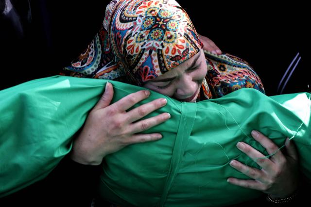 A Lebanese woman reacts as she grieves over the body of one of the nine people killed the day before in an Israeli airstrike on the southern Lebanese village of Jibshit, during their funeral in the city of Sidon on May 10, 2026. Israel carried out strikes across Lebanon on May 9, 2026, killing at least nine people, in the south according to authorities, with raids also targeting a highway not far from Beirut outside of Hezbollah's traditional strongholds. Lebanon was drawn into the Middle East war on March 2 when Tehran-backed militant group Hezbollah launched attacks on Israel to avenge the killing of the Iranian leader. Israel has responded with broad strikes across Lebanon and a ground offencive. (Photo by MAHMOUD ZAYYAT / AFP)