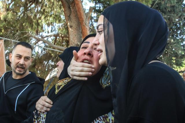 Lebanese relatives and friends react as the bodies of nine people killed the day before in the southern Lebanese village of Jibshit in an Israeli airstrike, are taken for burial in the city of Sidon on May 10, 2026. Israel carried out strikes across Lebanon on May 9, 2026, killing at least nine people, in the south according to authorities, with raids also targeting a highway not far from Beirut outside of Hezbollah's traditional strongholds. Lebanon was drawn into the Middle East war on March 2 when Tehran-backed militant group Hezbollah launched attacks on Israel to avenge the killing of the Iranian leader. Israel has responded with broad strikes across Lebanon and a ground offencive. (Photo by Mahmoud ZAYYAT / AFP)