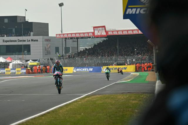 TOPSHOT - CF Moto Valresa Aspar Team's Spanish rider Maximo Quiles (L) celebrates as he crosses the line to win the Moto GP Grand Prix of France at Le Mans, northwestern France, on May 10, 2026. (Photo by Loic VENANCE / AFP)