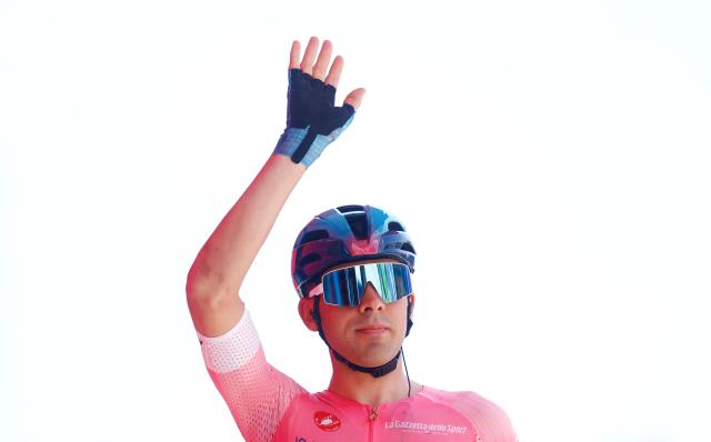 XDS Astana Team Uruguayan rider Guillermo Silva wearing the overall leader's pink jersey (Maglia Rosa) waves during the presentation of the teams prior the 3nd stage of the Giro d'Italia 2026 - Tour of Italy cycling race between Plovdiv and Sofia, Bulgaria, on May 10, 2026. (Photo by Luca Bettini / AFP)