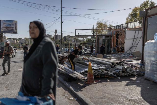 A Palestinian worker arranges building materials retrieved from a shop he is demolishing, ahead of the arrival of an Israeli army demolition team, in the Israeli-occupied Palestinian West Bank town of al-Eizariya, bordering East Jerusalem on May 10, 2026. Israel has a policy of demolishing the homes of Palestinians accused of deadly attacks against Israelis, saying it acts as a deterrent, as well as structures that Israel says are built without a licence. (Photo by ilia YEFIMOVICH / AFP)