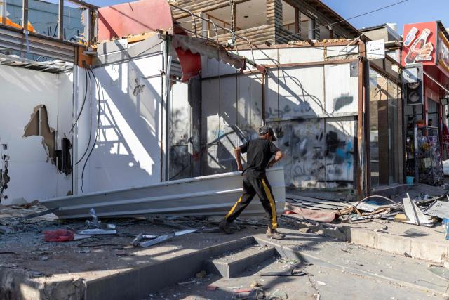A Palestinian worker removes building materials as he demolishes his shop, ahead of the arrival of an Israeli army demolition team, in the Israeli-occupied Palestinian West Bank town of al-Eizariya, bordering East Jerusalem on May 10, 2026. Israel has a policy of demolishing the homes of Palestinians accused of deadly attacks against Israelis, saying it acts as a deterrent, as well as structures that Israel says are built without a licence. (Photo by ilia YEFIMOVICH / AFP)