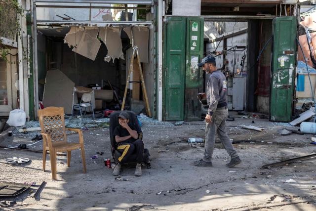 Palestinian workers take a break as they demolished shops, ahead of the arrival of an Israeli army demolition team, in the Israeli-occupied Palestinian West Bank town of al-Eizariya, bordering East Jerusalem on May 10, 2026. Israel has a policy of demolishing the homes of Palestinians accused of deadly attacks against Israelis, saying it acts as a deterrent, as well as structures that Israel says are built without a licence. (Photo by ilia YEFIMOVICH / AFP)