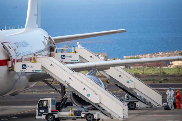 Spanish evacuees wearing white hazmat protective suits board a Spanish air force Airbus A310 plane at the Tenerife Sur-Reina Sofia airport after being evacuated from the Dutch flagged hantavirus-stricken cruise ship MV Hondius  on the island of Tenerife in Spain's Canary Islands on May 10, 2026. Repatriation flights for the nearly 150 passengers onboard the ship hit by a deadly hantavirus outbreak began as passengers were transferred to shore on smaller vessels then by bus to the airport to be flown home after weeks at sea. (Photo by Antonio Sempere / AFP)