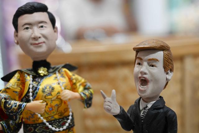 Plastic figures depicting China's President Xi Jinping (L) dressed as a Qing Dynasty emperor and US President Donald Trump (R) are displayed for sale in a store in Beijing on May 10, 2026. Trump is due to visit China on May 14-15 where he is expected to meet with China's President Xi after delaying an earlier summit due to the Middle East war. (Photo by Pedro PARDO / AFP)