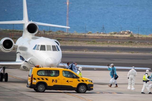 Passengers wearing blue protective suits board a French govenment plane at the Tenerife Sur-Reina Sofia airport after being evacuated from the Dutch flagged hantavirus-stricken cruise ship MV Hondius on the island of Tenerife in Spain's Canary Islands on May 10, 2026. Repatriation flights for the nearly 150 passengers onboard the ship hit by a deadly hantavirus outbreak got underway as passengers and some crew members were transferred to shore on smaller vessels then by bus to the airport and then flown home after weeks at sea. (Photo by Antonio Sempere / AFP)