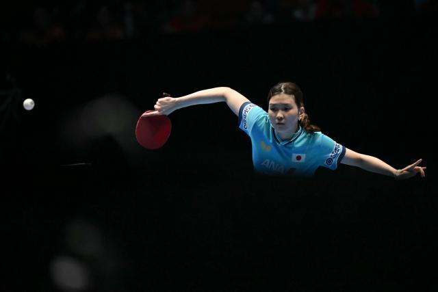 Japan's Honoka Hashimoto returns against China's Kuai Man during their Women's Teams final match at the ITTF World Table Tennis Championships in Wembley Arena, west London on May 10, 2026. (Photo by Glyn KIRK / AFP)
