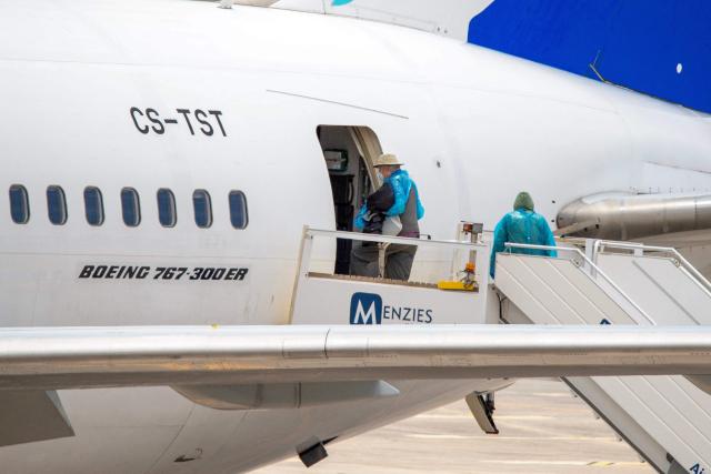 Canadian passengers board a plane at the Tenerife Sur-Reina Sofia airport after being evacuated from the Dutch flagged hantavirus-stricken cruise ship MV Hondius on the island of Tenerife in Spain's Canary Islands on May 10, 2026. Repatriation flights for the nearly 150 passengers onboard the ship hit by a deadly hantavirus outbreak got underway as passengers and some crew members were transferred to shore on smaller vessels then by bus to the airport and then flown home after weeks at sea. (Photo by Antonio Sempere / AFP)
