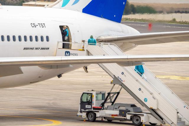 Canadian passengers board a plane at the Tenerife Sur-Reina Sofia airport after being evacuated from the Dutch flagged hantavirus-stricken cruise ship MV Hondius on the island of Tenerife in Spain's Canary Islands on May 10, 2026. Repatriation flights for the nearly 150 passengers onboard the ship hit by a deadly hantavirus outbreak got underway as passengers and some crew members were transferred to shore on smaller vessels then by bus to the airport and then flown home after weeks at sea. (Photo by Antonio Sempere / AFP)