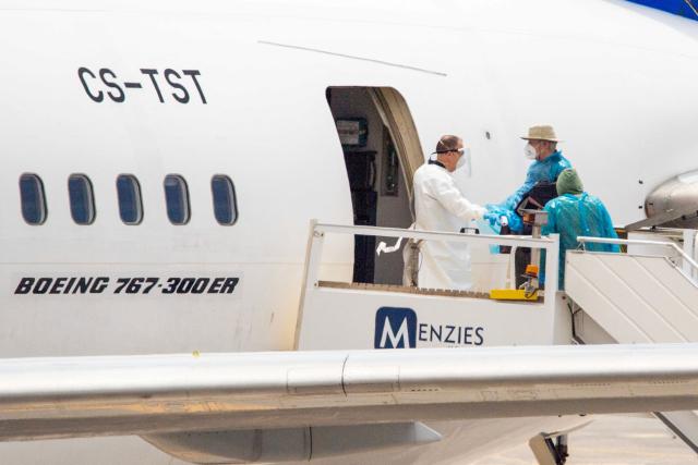 Canadian passengers board a plane at the Tenerife Sur-Reina Sofia airport after being evacuated from the Dutch flagged hantavirus-stricken cruise ship MV Hondius on the island of Tenerife in Spain's Canary Islands on May 10, 2026. Repatriation flights for the nearly 150 passengers onboard the ship hit by a deadly hantavirus outbreak got underway as passengers and some crew members were transferred to shore on smaller vessels then by bus to the airport and then flown home after weeks at sea. (Photo by Antonio Sempere / AFP)
