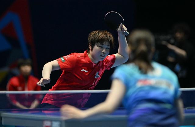 China's Kuai Man returns to Japan's Honoka Hashimoto during their Women's Teams final match at the ITTF World Table Tennis Championships in Wembley Arena, west London on May 10, 2026. (Photo by Glyn KIRK / AFP)