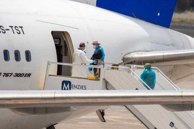 Canadian passengers board a plane at the Tenerife Sur-Reina Sofia airport after being evacuated from the Dutch flagged hantavirus-stricken cruise ship MV Hondius on the island of Tenerife in Spain's Canary Islands on May 10, 2026. Repatriation flights for the nearly 150 passengers onboard the ship hit by a deadly hantavirus outbreak got underway as passengers and some crew members were transferred to shore on smaller vessels then by bus to the airport and then flown home after weeks at sea. (Photo by Antonio Sempere / AFP)