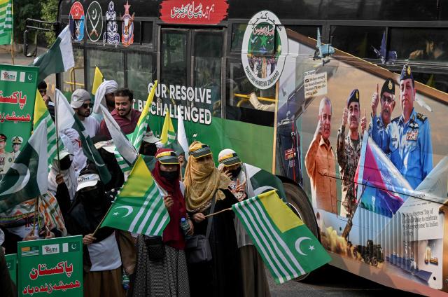 Youth Forum for Kashmir (YFK) activists hold a banner reading "Bunyan-um-Marsoos" as they march during a rally to mark one year since the India-Pakistan conflict, in Lahore on May 10, 2026. (Photo by Arif ALI / AFP)