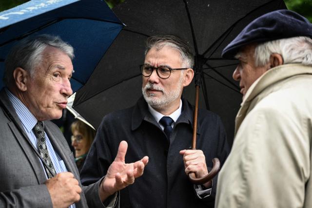 First Secretary of the French Socialist party (PS) and Socialistes et Apparentes' MP Olivier Faure (C) speaks with Gilbert Mitterrand (L), son of former French president François Mitterrand at the François Mitterrand Memorial Garden during the inauguration ceremony of the Cité des présents (former Musée du septennat) in Château-Chinon, central-eastern France, on May 10, 2026. After seven years of work, the new complex, renamed Cité des présent, was inaugurated on May 10, the 45th anniversary of the 1981 presidential election. The complex includes a fashion museum and a gift museum, which displays nearly 350 objects received by François Mitterrand during visits to 86 countries during his two seven-year terms (1981-1995). (Photo by ARNAUD FINISTRE / AFP)