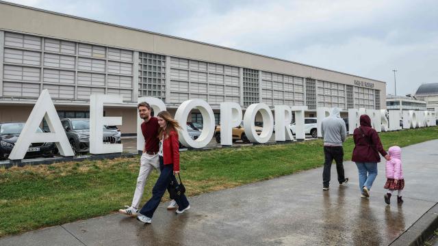 Pedestrians walk at Paris Le Bourget airport where a plane repatriating French nationals passengers of the MV Hondius on which an outbreak of hantavirus was been detected is expected to land, in Le Bourget, in the outskirts of Paris on May 10, 2026. The evacuation of the approximately 150 passengers and crew members of the MV Hondius, where an outbreak of hantavirus has been detected, began on on May 10, 2026 with the Spanish and French nationals at a port on the island of Tenerife in the Canary Islands; the operation, which is being closely monitored, is set to continue until May 11. The World Health Organisation (WHO) has identified six confirmed cases of hantavirus out of eight suspected cases, including three people who have died from this known but rare virus, for which there is neither a vaccine nor a treatment. (Photo by Xavier GALIANA / AFP)