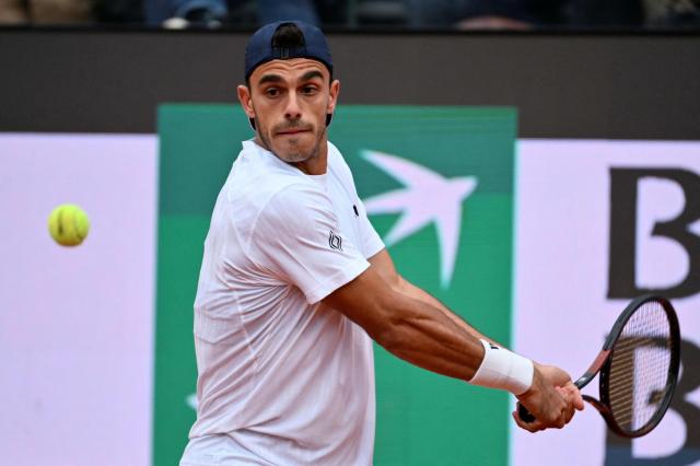 Argentina's Francisco Cerundolo hits a return to Italy's Lorenzo Musetti during their men's singles match at the ATP Rome Open tennis tournament at Foro Italico in Rome on May 10, 2026. (Photo by Alberto PIZZOLI / AFP)