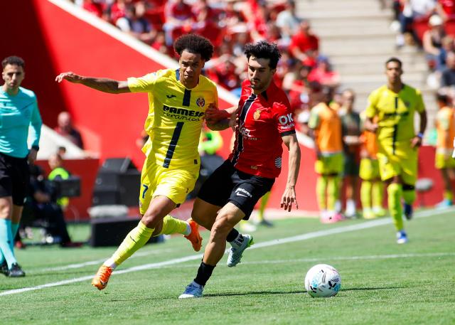Villarreal’s Canadian forward #17 Tajon Buchanan (L) vies with Real Mallorca’s Spanish midfielder #8 Manu Morlanes during the Spanish league football match between RCD Mallorca and Villarreal CF at Mallorca Son Moix Stadium in Palma de Mallorca on May 10, 2026. (Photo by JAIME REINA / AFP)