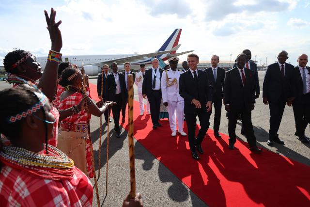 France's President Emmanuel Macron (C) watches traditional dancers perform upon his arrival ahead of the Africa Forward: Africa- France Partnerships for Innovation and Growth Summit in Nairobi, on May 10, 2026. Kenya and France will jointly host the “Africa Forward: Africa- France Partnerships for Innovation and Growth” Summit, which will bring together African and French Heads of State and Government. (Photo by Ludovic MARIN / AFP)