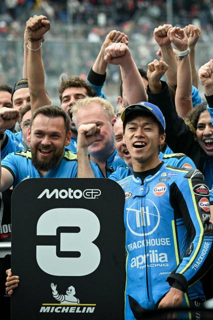 Trackhouse Racing MotoGP Team's Japanese rider Ai Ogura celebrates with his team in parc ferme after finishing third in the Moto GP Grand Prix of France at Le Mans, northwestern France, on May 10, 2026. (Photo by Loic VENANCE / AFP)