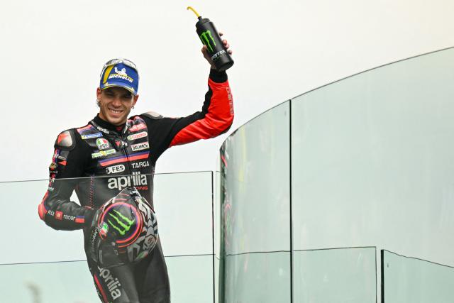 Aprilia Racing's Italian rider Marco Bezzecchi celebrates on the podium after finishing second in the Moto GP Grand Prix of France at Le Mans, northwestern France, on May 10, 2026. (Photo by Loic VENANCE / AFP)