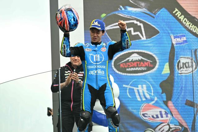 Trackhouse Racing MotoGP Team's Japanese rider Ai Ogura celebrates on the podium after finishing third in the Moto GP Grand Prix of France at Le Mans, northwestern France, on May 10, 2026. (Photo by Loic VENANCE / AFP)