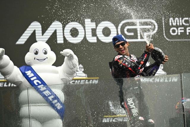 TOPSHOT - Aprilia Racing's Spanish rider Jorge Martin celebrates his victory on the podium at the end of the Moto GP Grand Prix of France at Le Mans, northwestern France, on May 10, 2026. (Photo by Loic VENANCE / AFP)