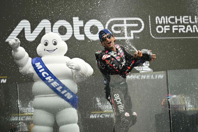 Aprilia Racing's Spanish rider Jorge Martin celebrates his victory on the podium at the end of the Moto GP Grand Prix of France at Le Mans, northwestern France, on May 10, 2026. (Photo by Loic VENANCE / AFP)