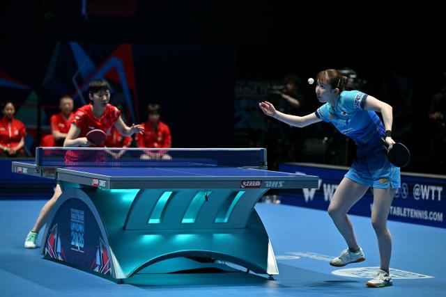 TOPSHOT - Japan's Hina Hayata serves against China's Wang Manyu during their Women's Teams final match at the ITTF World Table Tennis Championships in Wembley Arena, west London on May 10, 2026. (Photo by Glyn KIRK / AFP)