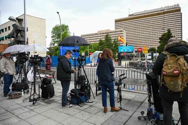 News media await the arrival of evacuated Sanish passengers from the Dutch flagged hantavirus-stricken cruise ship MV Hondius in front of the Gomez Ulla Defense Hospital in Madrid on May 10, 2026. Repatriation flights for the nearly 150 passengers onboard the ship hit by a deadly hantavirus outbreak got underway after the ship arrived to Tenerife in Spain's Canary Islands and passengers and some crew members were transferred to shore on smaller vessels then by bus to the airport and then flown home after weeks at sea. (Photo by Javier SORIANO / AFP)