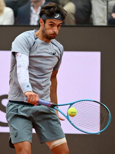 Italy's Lorenzo Musetti hits a return to Argentina's Francisco Cerundolo during their men's singles match at the ATP Rome Open tennis tournament at Foro Italico in Rome on May 10, 2026. (Photo by Alberto PIZZOLI / AFP)