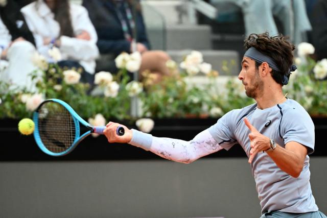 Italy's Lorenzo Musetti hits a return to Argentina's Francisco Cerundolo during their men's singles match at the ATP Rome Open tennis tournament at Foro Italico in Rome on May 10, 2026. (Photo by Alberto PIZZOLI / AFP)