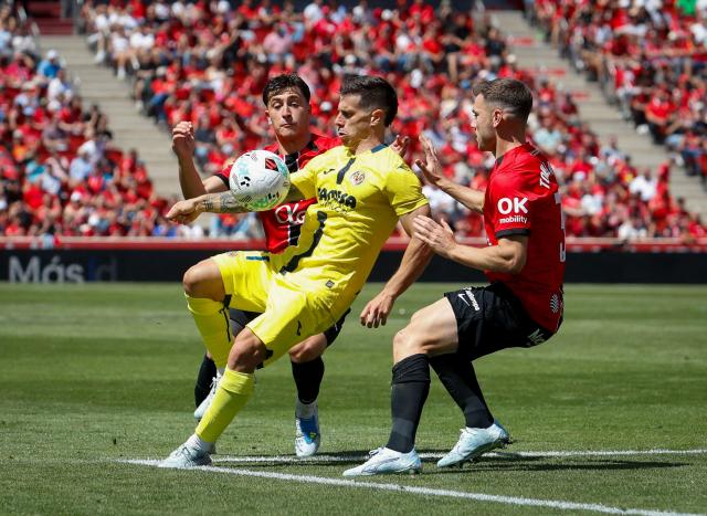 Villarreal’s Spanish forward #11 Alfonso Gonzalez vies with Real Mallorca’s Spanish defender #3 Toni Lato (R) and Real Mallorca’s Spanish forward #20 Pablo Torre during the Spanish league football match between RCD Mallorca and Villarreal CF at Mallorca Son Moix Stadium in Palma de Mallorca on May 10, 2026. (Photo by JAIME REINA / AFP)