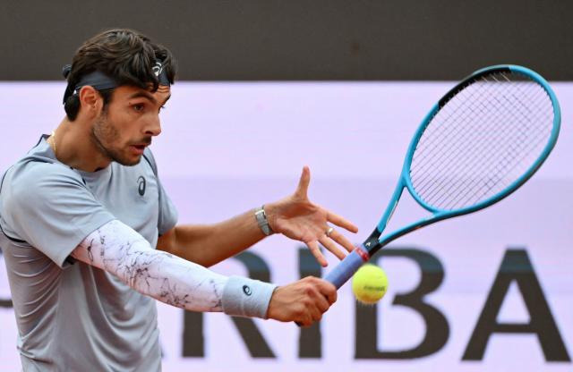 Italy's Lorenzo Musetti hits a return to Argentina's Francisco Cerundolo during their men's singles match at the ATP Rome Open tennis tournament at Foro Italico in Rome on May 10, 2026. (Photo by Alberto PIZZOLI / AFP)