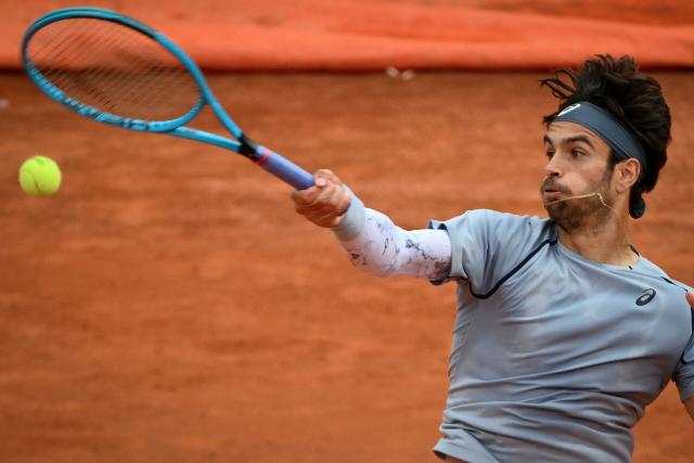 Italy's Lorenzo Musetti hits a return to Argentina's Francisco Cerundolo during their men's singles match at the ATP Rome Open tennis tournament at Foro Italico in Rome on May 10, 2026. (Photo by Alberto PIZZOLI / AFP)