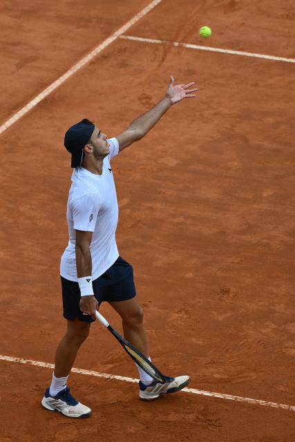 Argentina's Francisco Cerundolo serves to Italy's Lorenzo Musetti during their men's singles match at the ATP Rome Open tennis tournament at Foro Italico in Rome on May 10, 2026. (Photo by Alberto PIZZOLI / AFP)