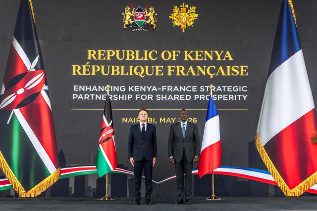 TOPSHOT - French President Emmanuel Macron (L) and Kenyan President William Ruto (R) listen to the national anthems during a reception at State House ahead of the Africa Forward: Africa- France Partnerships for Innovation and Growth Summit in Nairobi on May 10, 2026. Kenya and France will jointly host the “Africa Forward: Africa- France Partnerships for Innovation and Growth” Summit, which will bring together African and French Heads of State and Government. (Photo by Luis TATO / AFP)