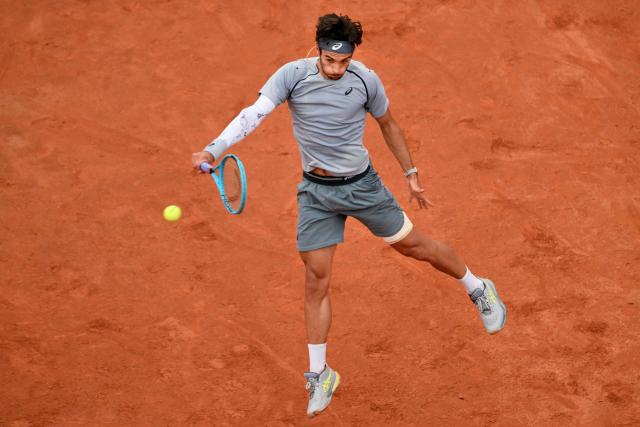 Italy's Lorenzo Musetti hits a return to Argentina's Francisco Cerundolo during their men's singles match at the ATP Rome Open tennis tournament at Foro Italico in Rome on May 10, 2026. (Photo by Alberto PIZZOLI / AFP)