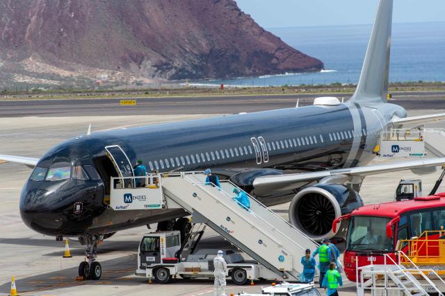 Passengers board a plane bound for the Netherlands at the Tenerife Sur-Reina Sofia airport after being evacuated from the Dutch flagged hantavirus-stricken cruise ship MV Hondius on the island of Tenerife in Spain's Canary Islands on May 10, 2026. Repatriation flights for the nearly 150 passengers onboard the ship hit by a deadly hantavirus outbreak got underway as passengers and some crew members were transferred to shore on smaller vessels then by bus to the airport and then flown home after weeks at sea. (Photo by Antonio Sempere / AFP)
