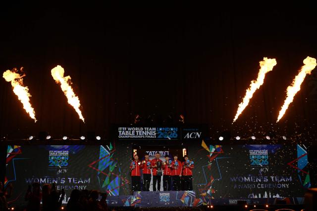 Team China celebrate with their trophies at the award ceremony after beating Japan in the Women's Teams final at the ITTF World Table Tennis Championships in Wembley Arena, west London on May 10, 2026. China won the final 3-2. (Photo by Glyn KIRK / AFP)