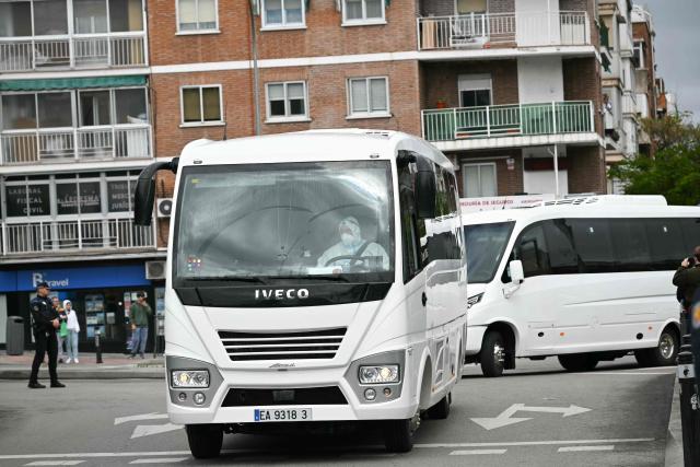 Spanish passengers that were evacuated from the Dutch flagged hantavirus-stricken cruise ship MV Hondius arrive in minibus to the Gomez Ulla Defense Hospital in Madrid. on May 10, 2026. Repatriation flights for the nearly 150 passengers onboard the ship hit by a deadly hantavirus outbreak got underway as passengers and some crew members were transferred to shore on smaller vessels then by bus to the airport and then flown home after weeks at sea. (Photo by Javier SORIANO / AFP)