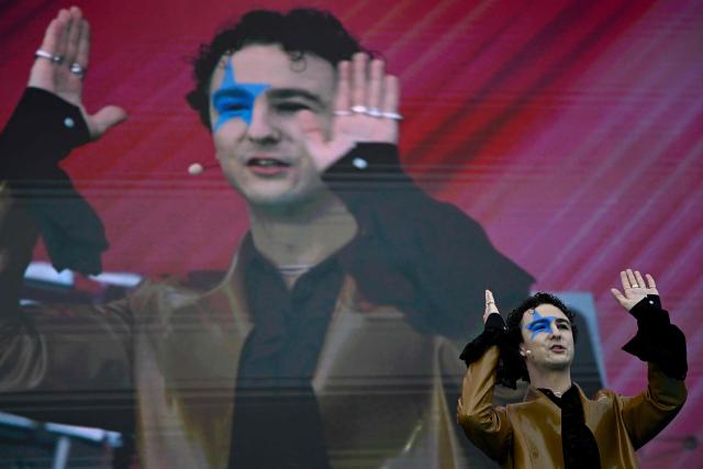 Austrian singer Benjamin Gedeon, aka Cosmo and representing Austria with the song 'Tanzschein', waves to supporters ahead of the opening ceremony of the Eurovision Song Contest 2026 at the City Hall Square in Vienna, Austria on May 10, 2026. The event is the official starting point of Eurovision week in Vienna. The city will host the two semi-finals on May 12 and May 14 and the final on May 16, 2026. (Photo by Tobias SCHWARZ / AFP)