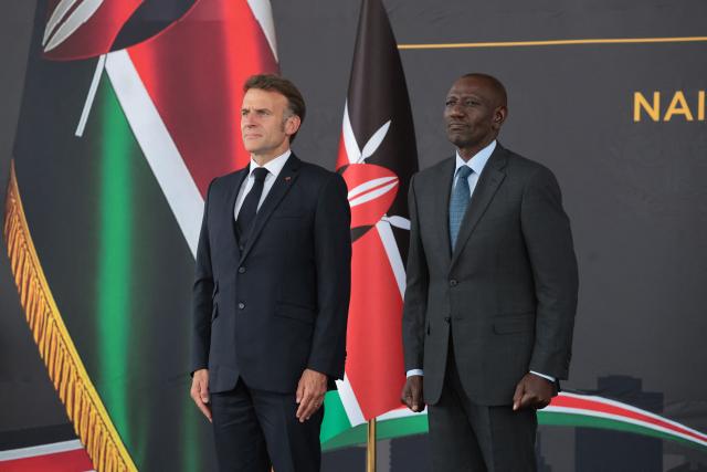 French President Emmanuel Macron (L) and Kenyan President William Ruto (R) listen to the national anthems during a reception at State House ahead of the Africa Forward: Africa- France Partnerships for Innovation and Growth Summit in Nairobi, on May 10, 2026. Kenya and France will jointly host the “Africa Forward: Africa- France Partnerships for Innovation and Growth” Summit, which will bring together African and French Heads of State and Government. (Photo by Ludovic MARIN / AFP)