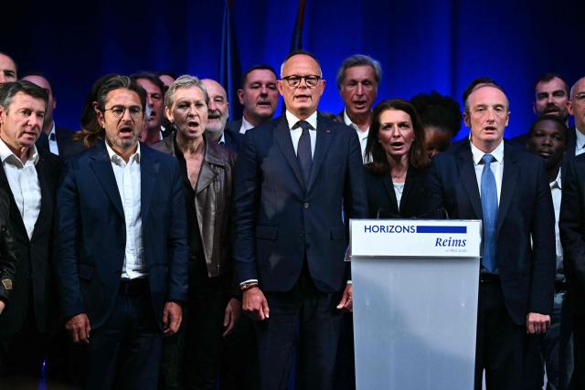 French right-wing party Horizons founder and president, mayor of Le Havre and candidate for the 2027 French presidential election Edouard Philippe (C) sings the French national anthem on stage with (From L) former mayor of Nice Christian Estrosi, Reims' mayor Arnaud Robinet, France’s junior Minister in charge of artificial intelligence Anne Le Henanff, former journalist turned politician Patrick de Carolis, Pays de la Loire region president Christelle Morancais and MP Laurent Marcangeli, at the end of a party’s senior officials rally in Reims on May 10, 2026. (Photo by Martin BUREAU / AFP)