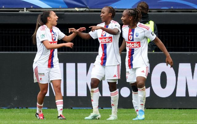 Lyon's French forward #07 Vicki Becho (C) celebrates with Paris Saint-Germain's Polish defender #04 Paulina Dudek (L) and Lyon's Haitian midfielder #06 Melchie Dumornay (R) after scoring a goal during the final of the women French football Cup between Paris Saint-Germain (PSG) and Lyon at the Hainaut stadium in Valenciennes on May 10, 2026. (Photo by Francois LO PRESTI / AFP)