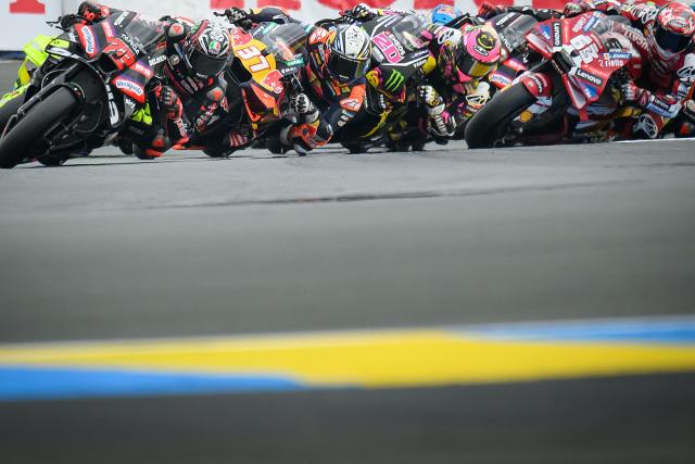 Aprilia Racing's Italian rider Marco Bezzecchi (L) leads the pack at the start of the Moto GP Grand Prix of France at Le Mans, northwestern France, on May 10, 2026. (Photo by Loic VENANCE / AFP)