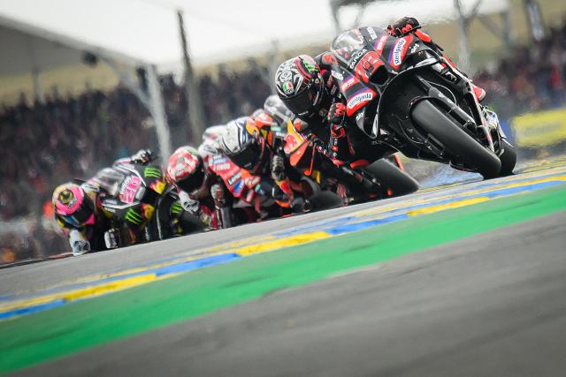 Aprilia Racing's Italian rider Marco Bezzecchi (R) corners as he leads the Moto GP Grand Prix of France at Le Mans, northwestern France, on May 10, 2026. (Photo by Loic VENANCE / AFP)