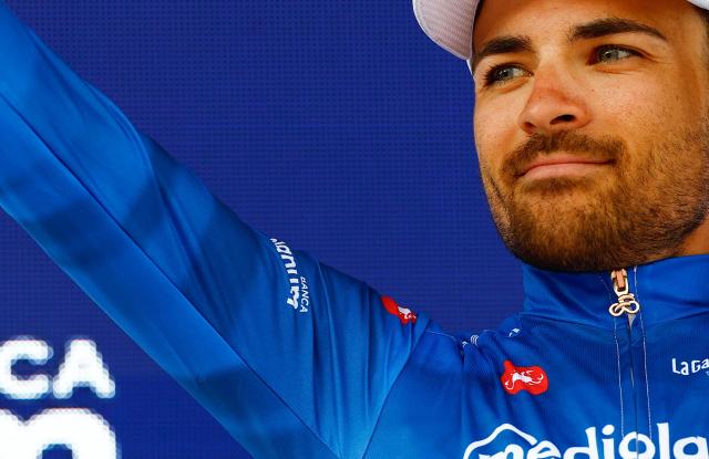 Team Polti VisitMalta Spanish rider Diego Sevilla wearing the best climber's blue jersey (Maglia Azzura) celebrates on the podium after the 3nd stage of the Giro d'Italia 2026 - Tour of Italy cycling race between Plovdiv and Sofia, Bulgaria, on May 10, 2026.  (Photo by Luca Bettini / AFP)